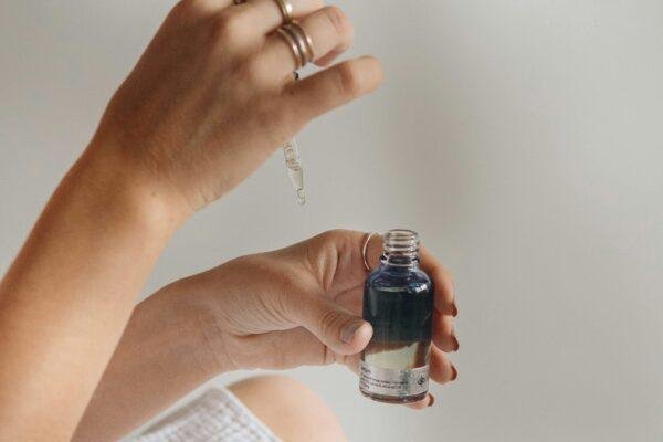 person holding black glass bottle